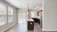 Located at 644 N Main St in Greenville, SC, this single-story, 4-bedroom, 3-bathroom home offers a well-designed layout with a thoughtful blend of finishes throughout. The open-concept living area features rich hardwood-style flooring and a ceiling fan, creating a comfortable and airy atmosphere. Multiple windows dressed with blinds allow natural light to fill the space while providing views of the surrounding greenery.

The kitchen is a standout feature, boasting granite countertops, rich dark cabinetry, stainless steel appliances including a refrigerator, electric range, and microwave, as well as a peninsula with pendant lighting — ideal for casual dining or entertaining. The kitchen flows seamlessly into the living area, enhancing the open feel of the home.

Each of the four bedrooms offers plush carpeting and neutral tones, providing a quiet and restful retreat. The primary bedroom includes a ceiling fan and ample natural light from well-positioned windows. The three bathrooms are finished with granite-topped dark vanities and hardwood-style flooring. Two bathrooms feature double-sink vanities and tub-shower combinations, offering both style and functionality. Throughout the home, clean white trim, panel doors, and a neutral color palette create a cohesive, modern aesthetic.