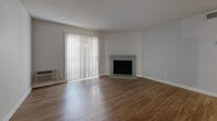Located at 2967 W Centennial Dr in Littleton, Colorado, this single-floor, one-bedroom, one-bathroom unit offers a well-organized layout across a compact but functional footprint. Wood-look flooring flows consistently throughout the space, creating a cohesive and easy-to-maintain interior.

The living room serves as the heart of the home, highlighted by a classic brick fireplace and a large sliding glass door dressed with vertical blinds that invite natural light and provide access to the outdoors. A pass-through opening connects the living area to the kitchen, enhancing the open feel of the space.

The kitchen is outfitted with rich dark cabinetry, granite-style countertops, a stainless steel sink, and track lighting overhead — offering both style and practicality. Adjacent to the kitchen, the entry hallway provides a welcoming transition into the unit.

The bedroom is a comfortable, well-lit room featuring a window with natural light and two closets, including a louvered bi-fold closet door. The bathroom includes wood-look flooring, a bathtub, and clean white finishes throughout.

A dedicated in-unit laundry room with washer and dryer hookups adds everyday convenience, while a separate utility room rounds out the functional offerings of this well-appointed Littleton residence.