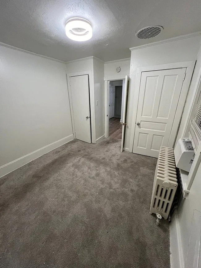 Bedroom with two spacious closets, radiator heat, and one window - 12 E Lancaster Ave