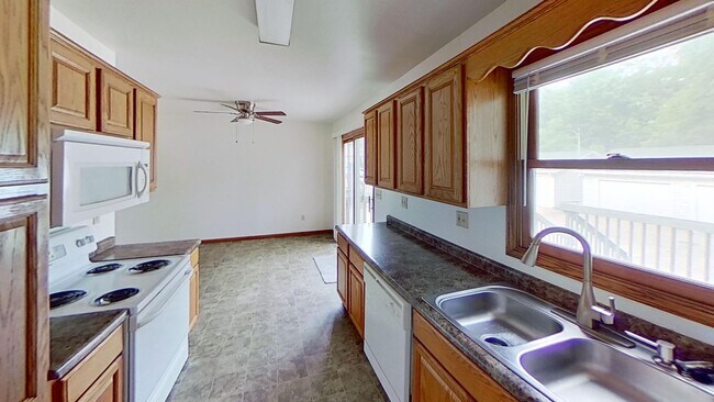 Building Photo - Two story duplex with two large bedrooms, walk in closet, one and a half bath, full basement, 12x...