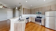 Located at 355 Amistead Ave in Fort Mill, SC, this single-floor home offers a well-designed layout with a clean, modern aesthetic throughout. The main living area features rich hardwood flooring that reflects natural light streaming in through multiple windows fitted with white blinds. A ceiling fan adds both function and style, while neutral gray walls create a versatile backdrop throughout the space.

The kitchen is a standout feature, outfitted with light wood cabinetry, granite countertops, and a classic white subway tile backsplash. Stainless steel appliances — including a refrigerator, range, microwave, and dishwasher — are complemented by pendant lighting and a kitchen island with a undermount sink, making it both practical and visually appealing.

The bedrooms offer plush carpeting underfoot, neutral-toned walls, and ceiling fans, with several rooms featuring windows that bring in views of the surrounding neighborhood. The bathroom includes a full tub-shower combination, granite vanity countertop, and wood-look flooring, maintaining the home's consistent, polished finish.

Overall, this home presents a cohesive design with practical finishes, ample natural light, and a comfortable, move-in-ready feel suited for everyday living in the Fort Mill community.