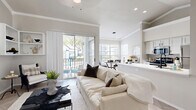 This contemporary 1020 sq ft apartment in Plano, TX, offers a harmonious blend of style and functionality. The open-concept living area features vaulted ceilings, creating an airy atmosphere enhanced by natural light from large windows. Herringbone pattern wood-look flooring adds a touch of elegance throughout.

The kitchen boasts white cabinetry, stainless steel appliances, and a generous island with a sink, perfect for meal prep and casual dining. The living room opens to a balcony overlooking the community pool, ideal for relaxation or entertaining.

The primary bedroom, spanning 150 sq ft, includes an en-suite bathroom and walk-in closet. A second bedroom and bathroom provide ample space for guests or a home office. Neutral tones and modern fixtures create a cohesive design aesthetic.

Thoughtful details like built-in shelving, stylish light fixtures, and a dedicated dining area enhance the apartment's functionality and appeal. The property's location at 801 Legacy Dr in Plano offers convenient access to local amenities.