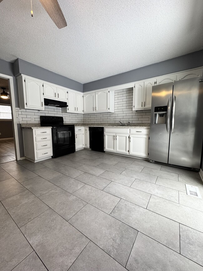 Kitchen with stainless refrigerator - 518 E 97 Terrace