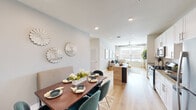 This single-floor residence at 13611 Perry Rd in Houston, TX offers a well-designed open-concept layout that seamlessly connects the kitchen, dining, and living areas. Light wood-tone flooring runs throughout, lending warmth and continuity to the space.

The kitchen is outfitted with white shaker-style cabinetry, granite countertops, a full suite of stainless steel appliances including a gas range, built-in microwave, dishwasher, and refrigerator, and a functional island with a natural wood surface. Adjacent to the kitchen, the dining area accommodates a full-sized table and benefits from recessed lighting and neutral wall tones.

The living area extends toward large windows dressed with sheer curtains and blinds, allowing generous natural light and a ceiling fan overhead. The bedrooms are comfortably sized, each featuring large windows with outdoor views, ceiling fans, and light-filled interiors. A walk-in closet with multiple hanging rods and shelving provides ample storage.

The bathroom includes a tiled soaking tub and shower combination, white cabinetry with granite countertops, and wood-look flooring. Clean lines, recessed lighting, and a consistent neutral palette contribute to the home's modern, cohesive aesthetic throughout.