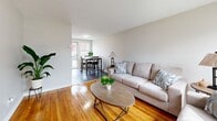 Located at 42 Brown St in East Hartford, CT, this two-floor apartment offers a practical and well-maintained layout with warm hardwood flooring featured prominently throughout most of the home. The main floor opens into a bright living room with natural light streaming through front-facing windows, seamlessly connecting to a dining area with direct access to an exterior door — ideal for easy outdoor entry. The kitchen is equipped with dark cabinetry, light stone-finish countertops, and stainless steel appliances, including a full-size refrigerator, set over wood-look flooring. A staircase leads to the upper floor, where both bedrooms and the full bathroom are situated. The primary bedroom features hardwood floors, a double window with neighborhood views, and direct access to the bathroom. The second bedroom also offers hardwood floors, natural light, a closet, and an open layout suitable for flexible use. The shared full bathroom includes white tile accents, a vanity with a dark wood base, and clean, neutral finishes throughout. The unit's consistent use of hardwood flooring, neutral wall tones, and natural light creates a cohesive and comfortable atmosphere across both levels.