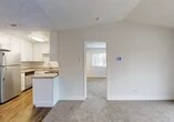 Located at 1401 Lakewood Ave in Modesto, CA, this 1-bedroom, 1-bathroom unit offers a thoughtfully laid-out floor plan across a single level. The living room is a bright, open space featuring soft carpeting, vaulted ceilings, and a sliding glass door that fills the room with natural light and provides access to an outdoor area with a railed view of the surrounding neighborhood.

The kitchen flows directly off the living area and is well-equipped with white shaker-style cabinetry, a peninsula breakfast bar, stainless steel appliances including a refrigerator and dishwasher, a cooktop range, a single-basin sink, and wood-look vinyl flooring that contrasts cleanly with the neutral tones throughout.

The bedroom offers a comfortable, carpeted retreat with a large window framing views of the tree-lined street, providing ample natural light. A closet is conveniently located just off the bedroom entrance, adding practical storage. The textured ceiling carries throughout the space, lending a consistent finish across all rooms.

The bathroom is clean and functional, featuring a full tub-shower combo, a single vanity with a stone-look countertop, a large mirror, and wood-look flooring. The overall aesthetic is bright, neutral, and move-in ready, making this a practical and comfortable residence in Modesto.