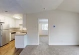 Located at 1401 Lakewood Ave in Modesto, CA, this 1-bedroom, 1-bathroom unit offers a thoughtfully laid-out floor plan across a single level. The living room is a bright, open space featuring soft carpeting, vaulted ceilings, and a sliding glass door that fills the room with natural light and provides access to an outdoor area with a railed view of the surrounding neighborhood.

The kitchen flows directly off the living area and is well-equipped with white shaker-style cabinetry, a peninsula breakfast bar, stainless steel appliances including a refrigerator and dishwasher, a cooktop range, a single-basin sink, and wood-look vinyl flooring that contrasts cleanly with the neutral tones throughout.

The bedroom offers a comfortable, carpeted retreat with a large window framing views of the tree-lined street, providing ample natural light. A closet is conveniently located just off the bedroom entrance, adding practical storage. The textured ceiling carries throughout the space, lending a consistent finish across all rooms.

The bathroom is clean and functional, featuring a full tub-shower combo, a single vanity with a stone-look countertop, a large mirror, and wood-look flooring. The overall aesthetic is bright, neutral, and move-in ready, making this a practical and comfortable residence in Modesto.