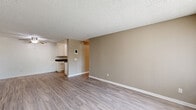 Located at 1435 Elder Avenue in San Diego, CA, this single-story, one-bedroom, one-bathroom home offers a functional and well-appointed layout across a compact yet efficient floor plan. The living room is a welcoming, open space finished with durable wood-style laminate flooring, warm neutral-toned walls, and a textured ceiling. A large window allows natural light to fill the room, creating a bright and airy atmosphere, while a second door provides additional access. The space flows directly into the galley-style kitchen, which features white cabinetry extending to the ceiling for ample storage, dark granite-style countertops, a stainless steel sink, and stainless appliances including a refrigerator and electric range. The bedroom is a comfortable, carpeted retreat with a window offering a view of mature tropical landscaping, lending a serene outdoor connection. Neutral walls and textured ceilings continue throughout, maintaining a cohesive aesthetic. The bathroom is clean and functional, with wood-style tile flooring, a white vanity with storage, and a full tub-shower combination with chrome fixtures. A hallway and closet complete the layout, offering practical storage solutions. This home presents a tidy, move-in-ready living space in a Southern California setting.