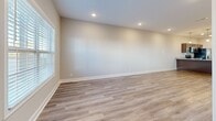 Located at 2500 Tiny Town Rd in Clarksville, TN, this two-story home offers 2 bedrooms, 3 bathrooms, and a well-designed layout spread across two floors. The main level features a bright, open living room finished with light wood-look luxury vinyl plank flooring and recessed lighting, with natural light streaming in through multiple windows. The kitchen is equipped with stainless steel appliances — including a refrigerator with ice maker, electric range, microwave, and dishwasher — complemented by rich dark wood cabinetry, granite countertops, and a convenient exterior door with a glass panel. A half bathroom on the main level adds practicality for guests. Upstairs, both bedrooms feature plush carpet flooring and ceiling fans with lighting. The generously sized primary bedroom receives ample natural light through a window with outdoor views. Two closets provide dedicated storage throughout the home. The three bathrooms include a clean tub-shower combo with built-in shelving and brushed nickel fixtures. Neutral warm tones and clean white trim are consistent throughout, creating a cohesive and move-in-ready atmosphere suited for comfortable everyday living.