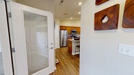 This single-story home in Indianapolis, IN offers a thoughtfully designed layout across one floor, combining comfort and functionality throughout. The living room impresses with soaring vaulted ceilings, a ceiling fan, and warm hardwood-style flooring that flows throughout the main areas, creating an open and airy atmosphere. A dedicated office space adjoins the living area, featuring a large window that fills the room with natural light—ideal for working from home.

The kitchen is well-equipped with warm wood cabinetry, granite countertops, stainless steel appliances including a refrigerator, range, and microwave, plus a peninsula with bar seating. A walk-in pantry provides generous storage. The adjacent dining area offers a cozy space for meals and gathering.

The primary bedroom is a comfortable retreat with plush carpeting, a ceiling fan, and a window with outdoor views. Two closets and two full bathrooms serve the home, with one bathroom featuring accessibility-friendly grab bars and a tub/shower combo with hardwood-style flooring.

Completing the home is a spacious attached two-car garage with an automatic opener and windows for added light. Every room reflects a clean, neutral palette and practical design tailored to everyday living.