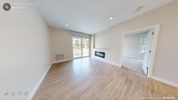 This single-floor residence at 505 Sutton St in North Andover, Massachusetts, presents a thoughtfully designed layout with contemporary finishes throughout. The kitchen serves as a central highlight, featuring crisp white cabinetry extending to the ceiling, a striking quartz-topped island with elegant veining, pendant lighting, a neutral tile backsplash, and a full suite of stainless steel appliances. Light hardwood-style flooring runs through the kitchen and main living areas, creating a cohesive, clean aesthetic.

The living area is bright and open, anchored by a sleek, modern fireplace with a linear design. A sliding glass door provides direct access to an outdoor space and allows natural light to fill the room. Neutral warm-toned walls complement the light flooring throughout.

The bedrooms are carpeted for comfort and feature large windows that frame outdoor views, filling the rooms with natural light. One bedroom includes a generous walk-in closet fitted with multi-level wire shelving and racking, while an additional closet provides supplementary storage. The overall design palette—neutral tones, clean lines, and quality materials—creates a cohesive, move-in-ready living environment.