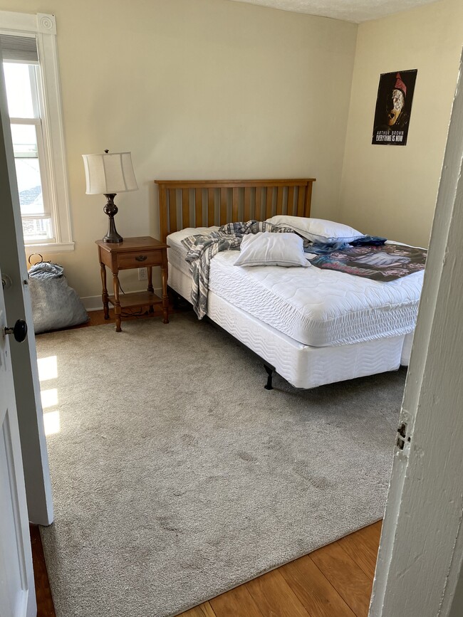 Primary bedroom with hardwood floor - 209 Main St