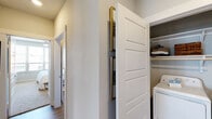 This well-designed 2-bedroom, 2-bathroom residence in Euless, TX offers a thoughtful single-floor layout with generous living space. The open-concept living and dining area is anchored by wood-style plank flooring, a ceiling fan, and large windows that invite an abundance of natural light and neighborhood views. The living room provides a comfortable gathering space, while the adjacent dining area accommodates a full dining table and benefits from its own bright window exposure.

The kitchen features white shaker-style cabinetry, light quartz countertops, a subway tile backsplash, and stainless steel appliances, combining a clean aesthetic with functional design. Both bedrooms are carpeted and receive ample natural light through large windows with blinds and ceiling fans overhead. The primary bedroom connects to a well-sized walk-in closet and a private en-suite bathroom complete with dual vanity sinks, quartz countertops, wood-style flooring, and a glass-enclosed walk-in shower.

A hallway connects the two bedrooms and leads to the secondary full bathroom. Additional highlights include two closets throughout and an in-unit laundry area with a full-size washer and dryer. The neutral color palette and modern finishes create a cohesive, move-in-ready atmosphere throughout.
