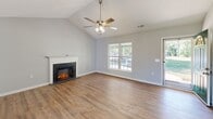Located at 632 Harkey Rd in Sanford, NC, this single-story, 2-bedroom, 2-bathroom home offers a well-organized and comfortable layout. The living room serves as the heart of the home, featuring soaring vaulted ceilings, a ceiling fan with light fixture, warm hardwood-style flooring, and a classic white-mantled electric fireplace that adds both style and ambiance. Natural light filters in through multiple windows, enhancing the home's airy feel. The kitchen is outfitted with white shaker-style cabinetry, granite-look countertops, a double sink, and black appliances including a gas range, dishwasher, microwave, and refrigerator. It flows directly into a combined dining area, creating a practical and open space for everyday living. The primary bedroom is generously sized, boasting vaulted ceilings, a ceiling fan, and a large window with outdoor views. The second bedroom features hardwood-style flooring and a textured ceiling. Both bathrooms are clean and functional, each equipped with a tub/shower combo and hardwood-style flooring. Additional highlights include a dedicated laundry room, four closets for ample storage, and a hallway connecting the home's spaces. A brick exterior entry adds charming curb appeal.