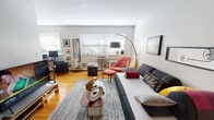 Located in Chicago's vibrant Lakeview neighborhood, this single-floor residence at 508 W Melrose St offers a well-appointed layout with thoughtfully designed living spaces. The open living area is a standout feature, showcasing warm hardwood flooring, bright windows that invite generous natural light, and a curated mix of contemporary and mid-century modern furnishings. A sculptural coffee table, layered area rug, and an eclectic gallery wall contribute to the space's distinctive character, while a dedicated seating nook with a coral accent chair and matching ottoman adds a cozy, functional corner.

The galley-style kitchen is efficiently designed and features rich dark cabinetry, granite countertops, a mosaic tile backsplash, and full-sized appliances — offering both style and practicality. Light wood-toned flooring ties the kitchen's aesthetic together seamlessly.

The bedroom provides a serene retreat with soft, neutral tones, hardwood floors, a large window dressed with layered curtains, and framed wall art that adds a refined touch. The bathroom is clean and modern, appointed with a dark wood vanity, a white basin countertop, a large mirror with medicine cabinet, and neutral tile throughout.

Overall, this residence presents a cohesive blend of comfort, personality, and urban practicality in one of Chicago's most desirable neighborhoods.