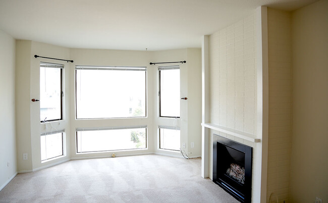 Living room with bay window and gas fireplace - 1915 California St