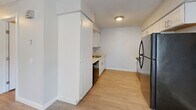Located at 2024 NE Terre View Dr in Pullman, WA, this 2-bedroom, 1-bathroom unit offers a practical and well-appointed single-floor layout. Throughout the unit, light-toned luxury vinyl plank flooring provides a clean, modern aesthetic, while textured ceilings and neutral gray walls create a bright, consistent backdrop across every room.

The kitchen is efficiently designed with white cabinetry offering ample storage, a built-in sink, a dishwasher, and a full-size stainless steel refrigerator. Light wood-tone flooring ties the kitchen seamlessly into the rest of the unit. Overhead lighting keeps the space well-illuminated.

Both bedrooms feature the same LVP flooring and neutral tones, with windows that allow natural light to filter in and provide views of the surrounding greenery. Baseboard heaters in each room ensure comfortable climate control year-round. The primary bedroom includes a closet with an arched panel door, adding a subtle architectural detail. The second bedroom is similarly sized and offers a quiet, functional space.

The bathroom is straightforward and clean, featuring a full tub and shower combination with white tile surround, a toilet, and tile flooring. The overall layout of the unit is compact yet thoughtfully arranged, making efficient use of every square foot for comfortable everyday living.