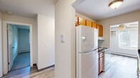 Located at 6421 Bridge Rd in Madison, Wisconsin, this single-floor residence offers three bedrooms, four bathrooms, and a well-organized layout designed for comfortable everyday living. The bedrooms are finished with soft carpeting and feature windows with blinds that allow natural light and views of the surrounding greenery. Each bedroom includes baseboard heating and wall-mounted air conditioning units, ensuring year-round comfort. At least one bedroom features a built-in sliding closet, providing practical storage. The bathrooms are a standout feature, with tiled tub-and-shower surrounds showcasing two distinct tile styles — one with a wood-look gray tile and another with a soft stone-patterned tile — paired with warm wood-toned vanities and light stone countertops. The kitchen is equipped with rich honey-toned cabinetry, dark laminate countertops, a double stainless steel sink, and ample upper and lower cabinet storage. Light wood-look flooring runs through the hallway and bathroom areas, creating a cohesive, clean aesthetic that connects the living spaces. The hallway is bright and open, linking the rooms efficiently. Overall, the home presents a clean, functional, and well-maintained environment suited for a variety of lifestyles.