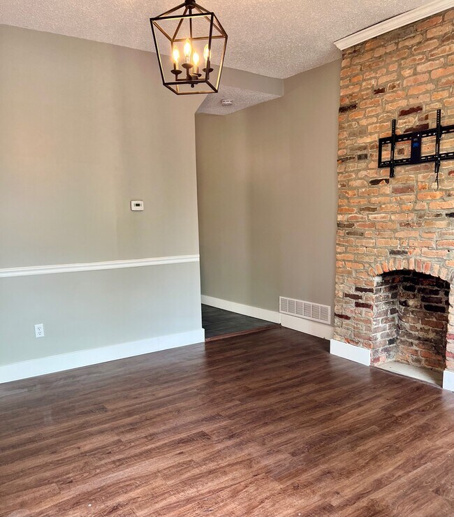 exposed brick and hardwood floors in the living room - 454 Forest St