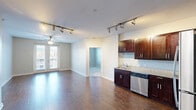 Located at 805 Canal St in Chattanooga, TN, this two-bedroom, two-bathroom residence offers a well-designed layout across a single floor. The open-concept kitchen and living area serves as the heart of the home, featuring rich hardwood flooring, dark espresso cabinetry, granite countertops, and a full suite of stainless steel appliances including a refrigerator, range, microwave, and dishwasher. Track lighting overhead adds a modern touch to the kitchen space.

The primary bedroom is a generously sized retreat with hardwood floors, a ceiling fan, and French doors that open to a private balcony with outdoor views of the surrounding neighborhood. The second bedroom offers plush carpeting and a bright window with natural light. Both bedrooms include dedicated closet space.

Each bathroom is finished with clean, neutral tiling. One features a full tub and shower combo lined with classic white subway tile, while the second bath is appointed with a granite-topped vanity. Neutral gray tones throughout the unit create a calm, cohesive ambiance. The thoughtful floor plan, ample storage, and quality finishes make this Chattanooga residence a functional and comfortable living space.