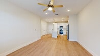 Located at 295 Royal Tern Cir in Rockledge, Florida, this single-story, one-bedroom, one-bathroom residence offers a thoughtfully designed open-concept layout. Light wood-style flooring runs throughout the entire unit, creating a cohesive and bright aesthetic.

The kitchen is a standout feature, boasting white shaker cabinetry that extends to the ceiling, a white quartz countertop island with pendant lighting above, and a full suite of stainless steel appliances including a refrigerator, range, microwave, and dishwasher. A subway tile backsplash and recessed lighting complete the polished look. The kitchen flows seamlessly into the living area, which is outfitted with a ceiling fan and recessed lighting, promoting an airy, open feel.

The bedroom is a well-proportioned, sun-filled room with dual windows allowing natural light, a ceiling fan, and a dedicated closet. A hallway connects the main living areas to the private spaces.

The bathroom features a white vanity with ample storage, a white quartz countertop, a large mirror, and a full tub and shower combo with neutral tile surround. Light wood-style flooring extends into the bathroom, maintaining a consistent design language. The space also includes access to an outdoor area through a glass-paned door.