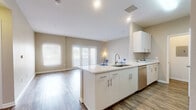 Located at 210 Summit Blvd in Broomfield, Colorado, this well-appointed 2-bedroom, 2-bathroom single-floor residence offers a thoughtfully designed layout with a clean, modern aesthetic throughout. The open-concept kitchen and living area serves as the heart of the home, featuring a large island with a quartz countertop, undermount sink, white cabinetry with sleek hardware, a tiled backsplash, and a full suite of stainless steel appliances including a refrigerator, range, microwave, and dishwasher. The living room extends naturally from the kitchen and is bathed in natural light through large windows and a set of French doors, complemented by warm wood-style hard flooring. Both bedrooms are carpeted and finished with neutral-toned walls, offering a calm and comfortable retreat. The primary bedroom is generously sized and includes a walk-in closet with wire shelving. The second bedroom also features a dedicated closet. The two bathrooms are finished with white vanities, quartz countertops, wood-style flooring, and tiled tub-shower combinations. Additional highlights include three closets for ample storage, two hallways, and a dedicated in-unit laundry area. The overall ambiance is bright, clean, and move-in ready.