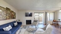 Located at 6155 Palm Ave in San Bernardino, CA, this well-appointed one-bedroom, one-bathroom unit offers a thoughtfully designed layout across a single floor. The open-concept living, dining, and kitchen area forms the heart of the home, creating a welcoming and functional space. The living room features wood-look flooring, a fireplace, and a sliding glass door that opens to a private balcony, allowing natural light to flow in and providing outdoor views. The kitchen is equipped with stainless steel appliances, including a gas range, over-the-range microwave, and refrigerator, complemented by white cabinetry, granite-style countertops, and a skylight that brightens the space. The adjacent dining area includes a ceiling fan and a sliding window overlooking the balcony. The generously sized bedroom offers plush carpeting, multiple windows for ample natural light, a textured ceiling, and access to a dedicated closet. The bathroom features a granite-style vanity countertop, white cabinetry, a large mirror, and a shower-tub combination with wood-look flooring throughout. The overall ambiance is bright, clean, and move-in ready, offering a comfortable living experience in a compact yet efficiently arranged space.