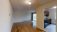 Located at 300 S Central Ave in Hartsdale, NY, this 2-bedroom, 1.5-bathroom residence offers a clean, functional layout across a single floor. The living area is finished with warm hardwood flooring that extends throughout, reflecting natural light and lending a sense of openness to the space. Neutral wall tones keep the interior bright and versatile, complementing a variety of furnishing styles. A sliding glass door in the main living area provides direct access to the outdoors and frames views of surrounding greenery, bringing in an abundance of natural light. Baseboard heating runs along the perimeter of the living room, ensuring year-round comfort. The layout flows efficiently between the living space and additional rooms, making practical use of the available square footage. With two well-proportioned bedrooms and a full bathroom alongside a convenient half bath, the residence accommodates both everyday living and hosting with ease. The overall ambiance is calm and uncluttered, offering a solid foundation for personalization. Its location in Hartsdale provides residents with access to local amenities, transit options, and the natural surroundings of Westchester County.