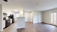 Located at 4791 Hickory Creek Dr in University Park, Illinois, this single-floor home offers a well-designed, open-concept layout that promotes a seamless flow between living spaces. The main living area features durable hardwood-style flooring, neutral-toned walls, and multiple windows that invite generous amounts of natural light, creating a bright and welcoming atmosphere. A ceiling fan adds both comfort and style to the space.

The kitchen is thoughtfully appointed with white cabinetry, granite-look countertops, a breakfast bar peninsula, black appliances including a refrigerator, electric range, and dishwasher, as well as a stainless steel sink. The kitchen connects openly to the living and dining areas, making it ideal for entertaining.

The bedrooms are carpeted for added comfort and warmth, each featuring neutral walls and ample natural light from well-placed windows with outdoor views of the surrounding greenery. At least one bedroom includes a dedicated closet with built-in shelving, providing practical storage solutions.

The home's clean, contemporary finishes, consistent color palette of whites and soft grays, and thoughtful single-level floor plan make it a functional and comfortable residence in the University Park community.