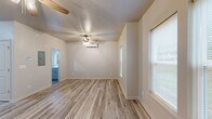 Located at 5339 US-319 S in Thomasville, Georgia, this thoughtfully designed one-bedroom, one-bathroom unit offers a clean, modern aesthetic across a single floor. Light-toned wood-look flooring flows consistently throughout, creating a cohesive and bright atmosphere. The living room is an open, welcoming space with a ceiling fan, wall-mounted mini-split climate control, and windows that allow natural light to fill the room. The kitchen is well-appointed with gray shaker-style cabinetry, white countertops, a stainless steel sink, and stainless steel appliances including a range with overhead ventilation. Ample upper and lower cabinet storage is complemented by a dedicated pantry, providing generous organizational space. The bedroom is comfortably sized, featuring a ceiling fan, wall-mounted mini-split unit, and multiple windows that invite natural light. A closet offers convenient in-room storage. The bathroom is cleanly finished with a gray vanity, white countertop, a full soaking tub with tile surround, and wood-look tile flooring that ties the space together. Neutral wall tones throughout contribute to a fresh, move-in-ready feel, making this unit a practical and attractive option in the Thomasville area.
