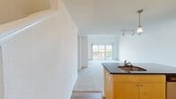 This contemporary 1-bedroom apartment at Sullivan Place (One Bedroom A1CL 15-6407) showcases a thoughtful design spread across 1,110 square feet on two floors. The lower level, spanning 760 square feet, houses the main living areas. The kitchen is a standout feature, boasting vibrant yellow cabinetry, stainless steel appliances, and a practical island with a sleek black countertop. The open-plan layout seamlessly connects the kitchen to the carpeted living room, creating an ideal space for both relaxation and entertainment.

The upper level, covering 350 square feet, likely contains the bedroom and additional living space. The bedroom, measuring 160 square feet, offers ample room and features a built-in closet for storage. Large windows in the living areas and bedroom flood the space with natural light and provide scenic views of the surrounding area.

The bathroom is well-appointed with a combination tub-shower, modern fixtures, and tiled flooring. Throughout the apartment, neutral wall colors and carpeting create a blank canvas for personalization. The inclusion of a balcony adds an outdoor element, perfect for enjoying fresh air or city views.

With two hallways, multiple closets, and an efficient layout, this apartment maximizes its square footage to offer a comfortable and stylish urban living experience.