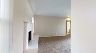 This one-bedroom, one-bathroom unit in Grand Prairie, Texas, offers a well-organized single-floor layout designed to maximize its compact footprint. The living area serves as the focal point of the space, featuring neutral beige walls, wall-to-wall carpet, and a white tile-surround fireplace that adds a distinctive architectural detail. Natural light enters through vertical-blind-covered windows, contributing to a bright, open feel. Recessed lighting and ceiling-mounted vents are integrated into the living area ceiling.

The kitchen is efficiently laid out with gray cabinetry, speckled laminate countertops, wood-look vinyl plank flooring, and a dishwasher. A window with vertical blinds provides natural light, and a separate door offers additional access.

The bedroom is a comfortable, well-proportioned space with plush carpet, two windows fitted with vertical blinds, and a ceiling fan with light fixture. The neutral walls and multiple electrical outlets offer practical flexibility for furnishing.

The bathroom features wood-look vinyl plank flooring, a full-size soaking tub with a white surround, built-in shelving, and a clean, minimalist finish. A hallway connects the rooms, and an entrance area completes the functional flow of this efficiently designed unit.