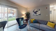 Located at 900 Berlington in Omaha, Nebraska, this single-floor unit offers a thoughtfully designed open-concept layout that connects the living, dining, and kitchen areas into one cohesive space. The living room is generously sized, featuring durable wood-look flooring, neutral gray walls, and large sliding glass doors that invite natural light and provide direct access to an outdoor area with exterior views. The open flow between the living and dining zones supports both everyday living and entertaining.

The galley-style kitchen is efficiently arranged with light wood cabinetry, ample counter space, a double-basin sink, and stainless steel appliances including a refrigerator, range, and dishwasher. A breakfast bar provides additional seating and connects the kitchen to the main living area.

The bedroom is a comfortable retreat finished with plush carpeting and a ceiling fan. It benefits from a window that adds natural light and connects to a spacious walk-in closet outfitted with multiple hanging rods and shelving for organized storage.

The bathroom features wood-look flooring, a warm wood vanity with storage drawers, a large mirror, and a shower-tub combination. The overall ambiance throughout the unit is clean, contemporary, and functional.