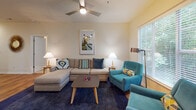 This single-floor residence at 100 Crescent Arbor Ln in Cary, NC, offers a thoughtfully designed layout that balances comfort and functionality throughout its living spaces. Rich hardwood flooring flows through the main living areas, complemented by warm, neutral-toned walls that create a bright and welcoming atmosphere.

The living room serves as the heart of the home, featuring a ceiling fan, ample natural light from large windows, and sliding glass doors that open to a private balcony with wooded views. The space accommodates generous seating arrangements and provides a relaxed, open feel.

The kitchen is well-equipped with warm wood cabinetry, dark appliances including a range, microwave, and refrigerator, and a granite-topped breakfast bar that connects seamlessly to the adjacent dining area — ideal for everyday meals and entertaining.

The bedrooms are carpeted and quietly comfortable. The primary bedroom includes a ceiling fan, a walk-in closet, and access to a private bathroom. Additional bedrooms feature natural light from windows and walk-in closets, offering practical storage. The bathrooms are finished with hardwood flooring, vanity cabinetry, and tub-shower combinations, providing clean and functional spaces throughout the home.