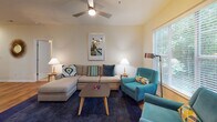 This single-floor residence at 100 Crescent Arbor Ln in Cary, NC, offers a thoughtfully designed layout that balances comfort and functionality throughout its living spaces. Rich hardwood flooring flows through the main living areas, complemented by warm, neutral-toned walls that create a bright and welcoming atmosphere.

The living room serves as the heart of the home, featuring a ceiling fan, ample natural light from large windows, and sliding glass doors that open to a private balcony with wooded views. The space accommodates generous seating arrangements and provides a relaxed, open feel.

The kitchen is well-equipped with warm wood cabinetry, dark appliances including a range, microwave, and refrigerator, and a granite-topped breakfast bar that connects seamlessly to the adjacent dining area — ideal for everyday meals and entertaining.

The bedrooms are carpeted and quietly comfortable. The primary bedroom includes a ceiling fan, a walk-in closet, and access to a private bathroom. Additional bedrooms feature natural light from windows and walk-in closets, offering practical storage. The bathrooms are finished with hardwood flooring, vanity cabinetry, and tub-shower combinations, providing clean and functional spaces throughout the home.