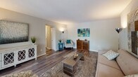 Located at 6112 Edsall Road in Alexandria, Virginia, this single-floor residence offers a well-designed layout that balances comfort and functionality. The open-concept living and dining area is a central highlight, featuring rich hardwood-style flooring, neutral gray walls, and ample natural light from large windows. The space flows seamlessly from a cozy seating area into a defined dining nook, creating an inviting environment for both relaxing and entertaining.

The kitchen is thoughtfully updated with light wood cabinetry, granite-look countertops, a classic white subway tile backsplash, and a full suite of appliances including a black refrigerator and dishwasher. Light wood-style flooring and a breakfast bar add to the kitchen's practical charm.

The residence includes two bedrooms. The primary bedroom features plush carpeting, soft neutral tones, and a window that brings in natural light, complemented by a spacious closet and access to additional storage. The second bedroom echoes a similar relaxed aesthetic with carpet flooring, natural light, and ample room for a workspace. The bathroom is clean and modern, featuring tile surround, a vanity with contemporary cabinetry, and a tub-shower combination. Throughout, the home maintains a cohesive, contemporary palette that is both welcoming and versatile.