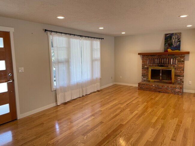 Living Room with working wood fireplace - 1395 NE Seward Ave