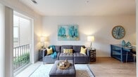Located at 424 E 36th St in Charlotte, NC, this single-floor unit offers a well-appointed, modern interior with consistent design details throughout. The kitchen is outfitted with stainless steel appliances — including a refrigerator, range, microwave, and dishwasher — complemented by granite countertops, a undermount sink, and a two-tone cabinet scheme pairing white upper cabinets with dark wood-grain lower cabinets, creating a sleek, contemporary aesthetic.

The living area features light wood-look flooring that runs throughout the unit, neutral walls, and large sliding glass doors that open to a private balcony with views of the surrounding Charlotte neighborhood. The bedrooms continue the light flooring and neutral palette, each equipped with ceiling fans and windows that bring in natural light.

Bathrooms are finished with granite-topped vanities, dark cabinetry, and a glass-enclosed walk-in shower with white subway tile. A dedicated storage room with an extensive wall-mounted wire shelving and basket system provides flexible organizational options. The overall layout, visible in the 3D overview, flows efficiently and makes practical use of the available space throughout.
