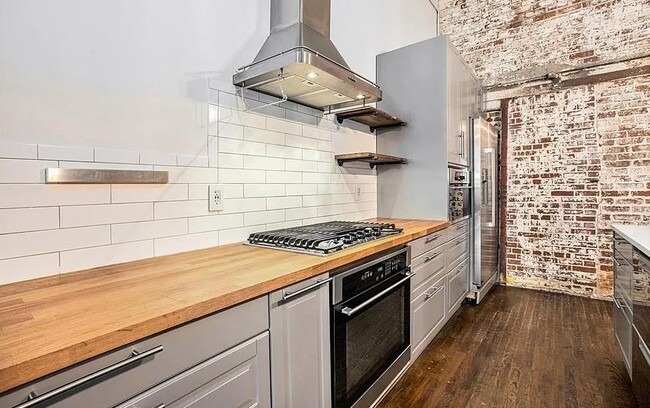 Butcher top counters, subway tile, and shaker cabinets. - 320 M L K Jr Dr SE