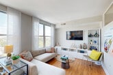 Located on the 7th floor at 1550 7th Street Northwest in Washington, DC, Unit 715 is a thoughtfully designed studio residence that maximizes its single-floor layout with an efficient and modern open-concept floor plan. Warm hardwood-style flooring flows throughout, lending continuity and a welcoming feel to the entire space.

The combined kitchen and living area forms the heart of the unit. The galley-style kitchen is outfitted with rich wood cabinetry, granite countertops, a white subway tile backsplash, and a full suite of stainless steel appliances including a range, microwave, dishwasher, and refrigerator. Track lighting overhead keeps the kitchen bright and functional. The open layout transitions seamlessly into a dining and living area, where large floor-to-ceiling windows invite abundant natural light and offer expansive outdoor views of the surrounding Washington, DC cityscape.

The bathroom is well-appointed with a combination tub and shower, white subway tile surround, granite-topped vanity with wood cabinetry, and neutral tile flooring. A dedicated closet provides practical storage solutions. Clean lines, neutral tones, and contemporary finishes throughout give the unit a cohesive, modern aesthetic well-suited for urban living in the heart of the nation's capital.