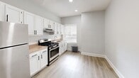 Located at 601 W Cliveden St in Philadelphia's Mt. Airy neighborhood, this one-bedroom, one-bathroom unit offers a thoughtfully designed layout across a single floor. Light wood-style flooring and neutral gray-white walls run throughout, creating a bright and cohesive aesthetic. The entrance leads into a central hallway, connecting all areas of the unit seamlessly. The spacious living room features recessed lighting and crown molding detail, providing a clean and versatile space for everyday living. The kitchen is well-appointed with white shaker cabinetry, a white subway tile backsplash, stainless steel gas range and refrigerator, and warm-toned countertops. A window allows natural light to fill the kitchen, which also features a classic cast-iron radiator. The bedroom is generously sized, offering two interior doors — one leading to a closet — along with a window and radiator. The bathroom is finished with neutral beige floor-to-ceiling tile surrounding the tub and shower, complemented by white tile flooring. A dedicated closet and entrance area round out the functional layout, making this a complete and comfortable urban residence.