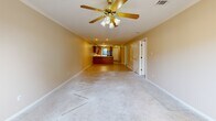 Located at 3020 Billy Jack Dr in Conway, Arkansas, this single-story, 2-bedroom, 2-bathroom home offers a practical and comfortable layout across a well-utilized floor plan. The entrance leads into a hallway finished with light tile flooring and crown molding, connecting the main living areas seamlessly. The spacious living room features plush carpet, a ceiling fan with light fixture, and crown molding, opening directly into the combined dining room and kitchen. The kitchen is equipped with warm oak cabinetry, a peninsula countertop with ample workspace, a built-in sink, white electric range, black refrigerator, and a built-in microwave — all finished with light tile flooring. The primary bedroom is generously sized, filled with natural light from a window, carpeted floors, a ceiling fan, and access to two closets. The second bedroom also features carpet, a ceiling fan, and its own closet. Both bathrooms include tub/shower combinations with sliding glass enclosures and tile flooring. Additional highlights include a dedicated laundry room, a utility room, and an attached garage with an automatic opener, textured ceiling, and concrete floors — offering excellent storage and parking capability. Six closets throughout the home provide exceptional storage.