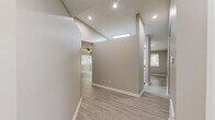Located at 130 W Crescent Square Dr in Graham, NC, this single-floor residence offers a well-organized layout featuring two bedrooms, two bathrooms, a living room, a utility room, a closet, and connecting hallways. The living room is finished with light-toned wood-look laminate flooring and is equipped with a ceiling fan with integrated lighting. A window with blinds allows natural light to filter in, offering views of surrounding greenery, creating a bright and welcoming atmosphere. Neutral greige walls and crisp white trim are carried consistently throughout the home, lending a clean and cohesive aesthetic. Both bedrooms are carpeted in a warm, neutral tone and receive natural light through windows fitted with blinds. The generously sized primary bedroom provides comfortable living space. Both bathrooms are finished with wood-look flooring and feature tub-shower combinations with curved curtain rods, white vanities with light stone-style countertops, and clean white fixtures. A dedicated utility room adds practical convenience to the home. The overall design is straightforward and functional, with consistent finishes throughout that make this residence a comfortable and move-in ready option in Graham, NC.