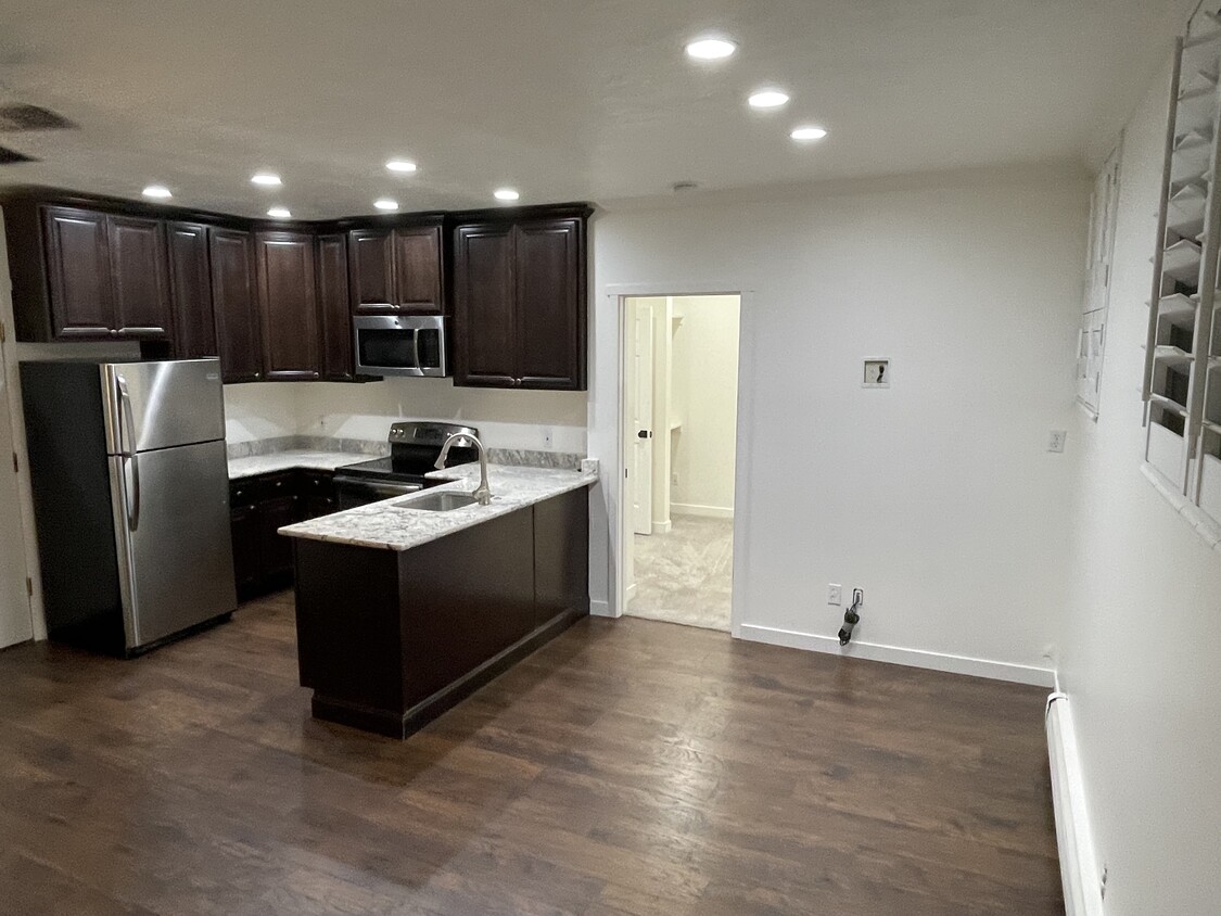 Kitchen. Bedroom door on right - 125 E 1st Ave