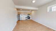 Located at 2528 NW Campus Village Way in Bend, Oregon, this one-bedroom, one-bathroom unit offers a thoughtfully designed single-floor layout that maximizes every square foot. The open-concept living and kitchen area serves as the heart of the home, featuring light wood laminate flooring that creates a clean, cohesive feel. The kitchen is equipped with a full suite of stainless steel appliances — including a refrigerator, range with microwave, and dishwasher — complemented by light natural wood cabinetry, white countertops, and a stainless steel sink. Recessed lighting illuminates the kitchen, while a flush ceiling fixture brightens the living area. The living room features a front entry door with a sidelite window, a wall-mounted HVAC unit, and ample natural light from multiple windows fitted with horizontal blinds. The bedroom is carpeted for comfort, offers its own window with outdoor views of the surrounding neighborhood, and includes a ceiling vent for climate control. The bathroom maintains the same light wood aesthetic with a wood-toned vanity, white countertop, a large mirror, and wood-look flooring, keeping the design consistent throughout the unit. Clean neutral walls and a modern, streamlined finish give this space a fresh, move-in-ready appeal.