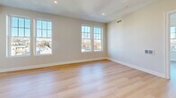 Located at 775 Morton St E in Boston's Mattapan neighborhood, this thoughtfully designed 3-bedroom, 1-bathroom residence offers a clean, modern aesthetic across a single floor. Light-toned hardwood flooring runs throughout the home, complementing the neutral warm-gray walls and crisp white trim that give each room a bright, cohesive feel.

The combined kitchen and living area serves as the heart of the home. The kitchen is well-appointed with white shaker-style cabinetry, gold-accented hardware, white quartz countertops, a gold-finish faucet, and a full suite of stainless steel appliances including a refrigerator with ice maker, electric range, built-in microwave, and dishwasher.

The three bedrooms are generously proportioned for the overall footprint, each featuring large double-hung windows that frame views of the surrounding Boston neighborhood and fill the rooms with ample natural light. The primary bedroom offers notable space and includes a full-size closet with paneled double doors. The bathroom is finished in a clean, contemporary style with marble-look tile flooring, a white vanity with gold hardware, a framed mirror, and a full tub-shower combination. A dedicated entrance and hallway provide a logical, organized flow throughout the home.