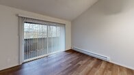 This 580 square foot, one-bedroom apartment in Tacoma, WA offers a blend of comfort and efficiency. The space is thoughtfully designed with a single floor layout, encompassing a living room, bedroom, kitchen, bathroom, and two hallways. The primary bedroom, measuring 150 square feet, provides ample space for rest and relaxation.

The bathroom is a standout feature, boasting a modern design with a spacious shower unit equipped with safety grab bars, a sleek toilet, and contemporary fixtures. The living area is characterized by its neutral color palette, with plush carpeting in some rooms and stylish wood-look flooring in others. Large windows in the living spaces allow for natural light, creating an open and airy atmosphere.

The kitchen, while compact, is efficiently designed with light-colored cabinetry, contrasting countertops, and essential appliances. The layout suggests a galley-style arrangement, maximizing space utility. Throughout the apartment, the walls are painted in a crisp white, providing a clean backdrop for personalization.

The apartment's design prioritizes functionality, with two closets offering storage solutions. The overall ambiance is modern and minimalist, suitable for urban living. The property at 2146 S Union Ave in Tacoma combines practicality with contemporary style, making it an ideal residence for individuals or couples seeking a compact yet comfortable living space.
