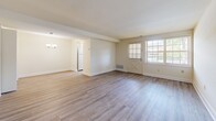 Located at 8 Chapeltowne Cir in Nottingham, MD, this two-bedroom, two-bathroom home spans two floors, offering a well-organized and functional layout. The main floor features a bright living room with light-toned luxury vinyl plank flooring, neutral walls, and a charming barn-style front door flanked by windows that fill the space with natural light. A carpeted staircase with a classic metal railing connects to the upper level. The galley-style kitchen is equipped with warm honey-toned wood cabinetry, gray laminate countertops, a double-basin sink, and white appliances including a range and refrigerator. Adjacent to the kitchen, the utility area includes an in-unit washer and dryer tucked behind louvered doors, a pendant light fixture, and a window with outdoor views. Both bedrooms feature LVP flooring and ample closet space — the primary bedroom is generously sized with a dedicated walk-in closet, while the second bedroom includes a double-door closet. The two bathrooms are clean and functional, one featuring a tub-shower combo with glass sliding doors and the other a stand-alone glass-door shower stall. Throughout the home, the consistent flooring, neutral palette, and natural light create a cohesive and inviting atmosphere.