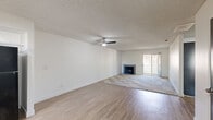 Located in Cathedral City, California, this single-story, 2-bedroom, 2-bathroom home offers a well-organized layout with a seamless flow throughout. The open living room is a welcoming central space featuring plush carpeting, a classic fireplace, and a sliding glass door that fills the room with natural light and provides access to the outdoors. A ceiling fan enhances comfort, and the open sightline into the kitchen makes the area feel expansive and connected. The kitchen is thoughtfully designed with two-tone cabinetry — crisp white upper cabinets paired with gray lower cabinets — complemented by stone-look countertops, a gas range, built-in microwave, and a window above the sink that brings in natural light. Light wood-look flooring grounds the space with a clean, modern finish. Both bedrooms are carpeted and feature textured ceilings, vertical blinds, and ample natural light from well-placed windows. The primary bedroom is generously sized and includes a wide sliding-door closet for practical storage. The two bathrooms are clean and functional, each equipped with a tub-shower combination, stone-look countertops, and large mirrors. Overall, the home offers a bright, neutral palette throughout.