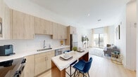 Located at 475 SW 27th Ave in Fort Lauderdale, FL, this thoughtfully designed 2-bedroom, 1-bathroom residence offers a bright, contemporary living experience across a generously sized single floor. The open-concept kitchen and living area serves as the heart of the home, featuring light wood cabinetry, white quartz countertops, a full suite of stainless steel appliances, a subway tile backsplash, and a central island with seating — ideal for casual dining and entertaining. Light wood-tone flooring runs throughout, complementing the crisp white walls and creating a cohesive, airy aesthetic. The living room is filled with natural light streaming through floor-to-ceiling sliding glass doors that open directly onto a private balcony, where panoramic views of Fort Lauderdale's lush, palm-lined streetscape await. The two bedrooms are well-proportioned and bright, with large windows framing outdoor views. The bathroom presents a clean, modern design with light wood vanity cabinetry, white countertops, and decorative greenery accents. A dedicated in-unit laundry room with full-size washer and dryer adds everyday convenience. Multiple living areas provide flexible space for both relaxation and functional use throughout this well-appointed South Florida residence.